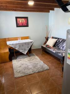 a living room with a table and a couch at Cabañas Casa Blanca in Valdivia