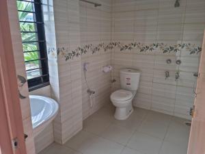 a bathroom with a toilet and a tub and a sink at M Ali House in Sylhet