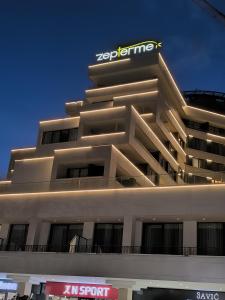 a building with a sign on the top of it at Zep Promenade Spa Apartment in Vrnjačka Banja