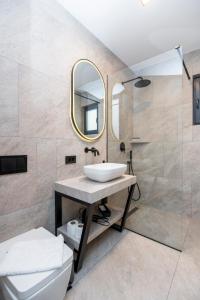 a bathroom with a sink and a mirror at Felicita Deluxe Apartments with Free Parking in Sarajevo