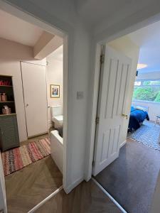 an empty room with a door open to a bedroom at Four Seasons B&B, Ground floor room, private bathroom, 3rd floor loft living area & self serve continental breakfast in Pitlochry +3 photos