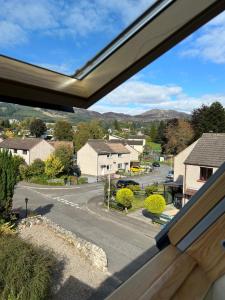 a view of a street from a house window at Four Seasons B&B, Ground floor room, private bathroom, 3rd floor loft living area & self serve continental breakfast in Pitlochry