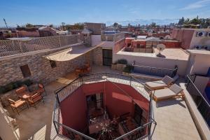 an apartment balcony with tables and chairs on a building at Zen Zone Boutique Riad & Spa in Marrakesh
