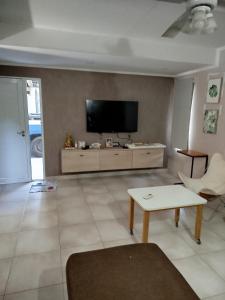 a living room with a flat screen tv on a wall at Casa Ramirez in Posadas