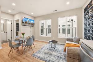 a living room with a table and a couch at LUX 1 BD Apartment In Union Market in Washington, D.C.