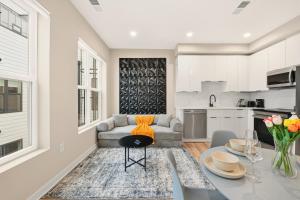 a kitchen and living room with a table and a couch at LUX 1 BD Apartment In Union Market in Washington, D.C.