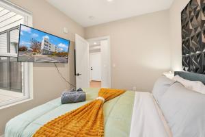 a bedroom with a bed and a flat screen tv at LUX 1 BD Apartment In Union Market in Washington, D.C. +9 photos