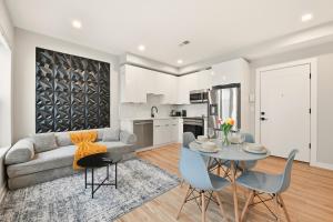 a living room with a couch and a table and chairs at LUX 1 BD Apartment In Union Market in Washington, D.C.