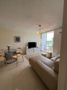 a living room with a couch and a television at Island bliss apartment in Fajardo