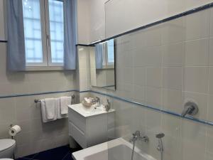 a bathroom with a sink and a toilet and a mirror at Pompei Blu Sant'Auri Apartment in Scafati +19 photos
