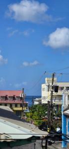 a view of a city with buildings and the ocean at Martha's House Kia in Soufrière