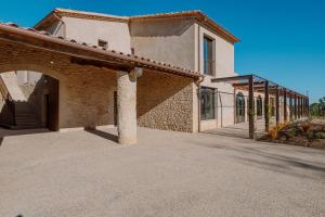 a brick building with a road in front of it at Hotel Mas Vidal Vilafreser in Vilademuls +94 photos