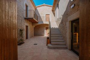 an empty alley with stairs in an old building at Hotel Mas Vidal Vilafreser in Vilademuls