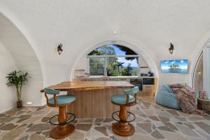 a kitchen with an island in the middle of a room at Sunshine Coast Hinterland Igloo Retreat Romantic & Private in Flaxton