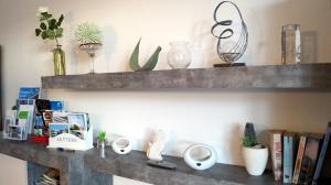 a shelf with plants and other items on it at Apartment 24 modern & gemütlich in Dessau