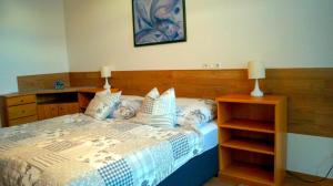 a bedroom with a bed with a wooden headboard at Apartment 24 modern & gemütlich in Dessau