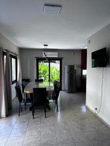a dining room with a table and black chairs at Shakti in Almafuerte