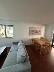 a living room with a couch and a table at Entire Studio in Moonee Ponds with Free Parking in Melbourne