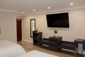 a bedroom with a bed and a television on the wall at Econo Lodge Lake Elsinore Casino in Lake Elsinore