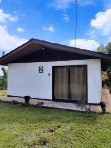 una piccola casa bianca con il numero sopra di Hills Villa Rio Celeste a Rio Celeste