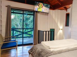 a bedroom with a bed and a tv on the wall at Nido de Montaña in Fraijanes