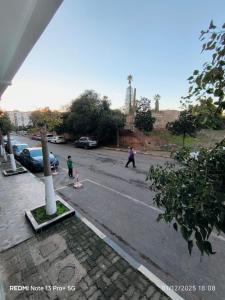 a group of people walking down a street at Appartement in Mohammedia