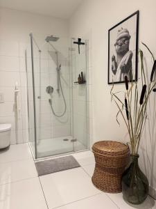 a bathroom with a shower and a toilet and a vase at Waldquartier Erzgebirge in Thermalbad Wiesenbad