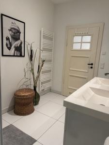 a bathroom with a sink and a picture of a man at Waldquartier Erzgebirge in Thermalbad Wiesenbad +22 photos