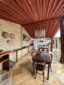 a dining room with a table and chairs at Pousada Ventoria in Canguaretama