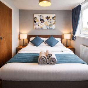a bedroom with a bed with towels on it at Denville Hotel in Blackpool