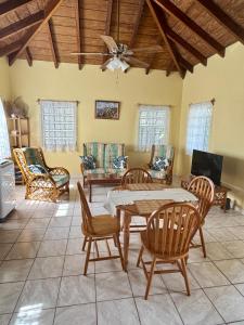 a living room with a table and chairs at Cotton Heights Guest House in Nevis