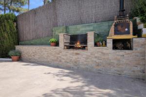 a fireplace in a brick wall with a fire place at Wonderful Villa, Heated Pool, Near Beautiful Xàtiva Town in Alboy +38 photos