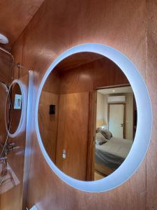 a circular mirror in a bathroom with a bed at N&L Signature - Ô Lodge in Mornas +20 photos