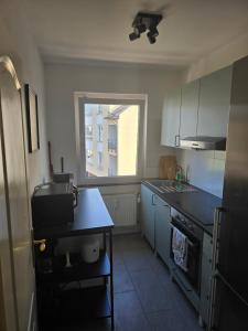 a kitchen with a counter top and a window at 3-Zimmer mitten in Siegburg in Siegburg