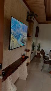 a television hanging on a wall in a room at Arenal Stone House in Ángeles
