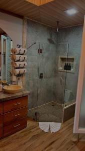 a bathroom with a shower and a sink at Arenal Stone House in Ángeles +36 photos