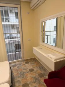 a room with a large window and a couch at Shengjin apartaments kozmai in Shëngjin +119 photos