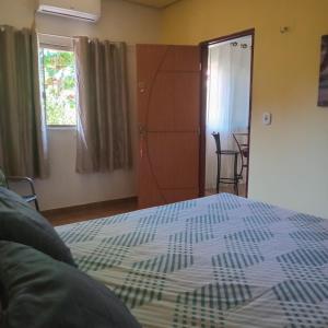 a bedroom with a bed and a window and a door at Carolina com Ká in Carolina +1 photo