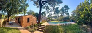 a house with a swimming pool next to a building at N&L Signature - Chambre d'hôtes in Mornas