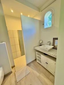 a bathroom with a sink and a mirror at N&L Signature - Chambre d'hôtes in Mornas +9 photos
