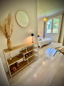 a living room with a large mirror on the wall at N&L Signature - Chambre d'hôtes in Mornas