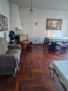 a living room with a couch and a table at Casa do Vans in São Gabriel