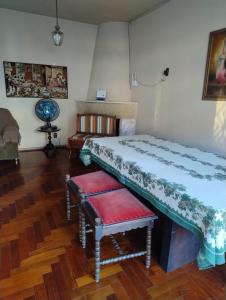 a room with two beds and a bench in it at Casa do Vans in São Gabriel