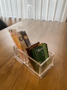 a plastic container filled with books on a table at コテージソラ まるっと一棟貸切り別荘 in Nasu-yumoto