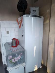 a white refrigerator in a kitchen with a towel on it at Casa do Vans in São Gabriel +13 photos