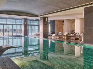 a swimming pool in a house with a living room at Fairmont Quasar Istanbul Hotel in Istanbul