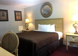 a hotel room with a bed and a mirror at ScottishINN Galloway in Galloway
