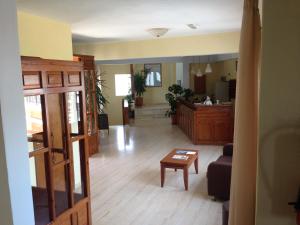 a living room with a couch and a table at Vontzos Hotel in Achladies