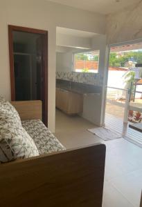 a bedroom with a bed and a bathroom with a sink at Flat Sétima Arte in Cairu +4 photos