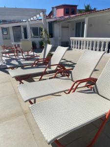 a row of chairs and tables on a patio at Flat Sétima Arte in Cairu